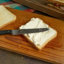 Для сэндвича с огурцом на два подрумяненных тоста намазываем творожный сливочный сыр