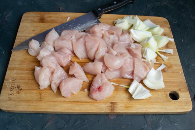 Нарезаем крупно куриное филе и луковицу 