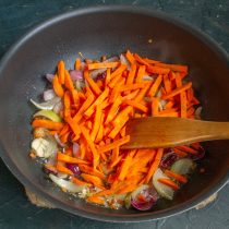 Добавляем нарезанную морковь, обжариваем всё вместе ещё 6-7 минут